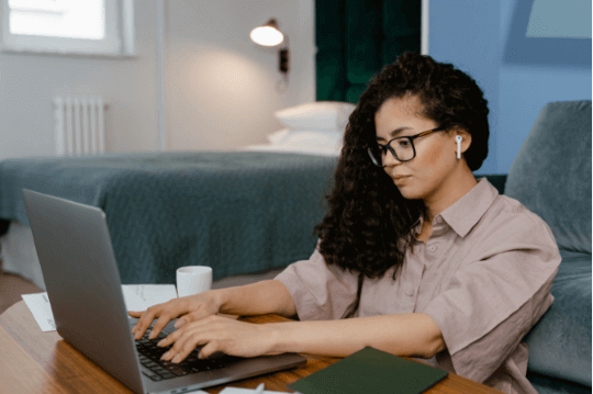 Woman writing Javascript using laptop